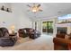Spacious living room with comfortable seating, fireplace, ceiling fan and access to the outdoors at 1674 Sw Beach Dr., Calabash, SC 28467
