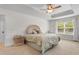 Relaxing bedroom features a large bed, soft carpet, tray ceiling, and a ceiling fan at 1674 Sw Beach Dr., Calabash, SC 28467