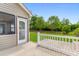 Back patio area with lush green lawn and an entrance to the screened-in porch at 1674 Sw Beach Dr., Calabash, SC 28467