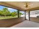 Screened in porch with ceiling fan overlooking the backyard and green foliage at 1674 Sw Beach Dr., Calabash, SC 28467