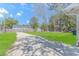 A spacious backyard with a driveway, green grass, and mature trees at 1931 Jasper St., Georgetown, SC 29440