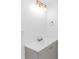 Modern bathroom features a gray vanity with a white countertop and updated lighting at 1931 Jasper St., Georgetown, SC 29440