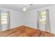 Spacious bedroom with hardwood floors, ceiling fan, and natural light from two windows at 1931 Jasper St., Georgetown, SC 29440