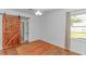 Cozy bedroom featuring hardwood floors, a barn door, and natural light from a window at 1931 Jasper St., Georgetown, SC 29440