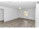 Minimalist bedroom with wood-look flooring, a ceiling fan, and a window providing natural light at 1931 Jasper St., Georgetown, SC 29440