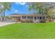 Charming single-story home with a well-manicured lawn, covered parking and vibrant flower bushes lining the front porch at 1931 Jasper St., Georgetown, SC 29440