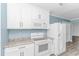 This kitchen features white appliances, cabinets, and countertop with gold accents and hardware at 1931 Jasper St., Georgetown, SC 29440