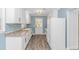 Bright kitchen features white cabinets, gold hardware, stainless appliances, and hardwood floors at 1931 Jasper St., Georgetown, SC 29440