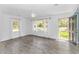 Bright living room featuring wood-look flooring, ample natural light, and a modern ceiling fan at 1931 Jasper St., Georgetown, SC 29440