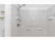 Updated shower with white tile, shelving, and chrome showerhead at 1931 Jasper St., Georgetown, SC 29440