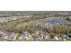 A scenic aerial view showcases the property's location within a charming neighborhood with lush greenery and a community lake at 200 Stonefly Ct., Murrells Inlet, SC 29576