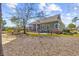 A spacious backyard featuring a well-maintained lawn, patio area, and lush landscaping, ideal for outdoor enjoyment at 200 Stonefly Ct., Murrells Inlet, SC 29576