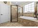 Bathroom featuring walk-in shower, soaking tub, and a window for natural light at 200 Stonefly Ct., Murrells Inlet, SC 29576