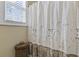 Bright bathroom featuring a patterned shower curtain, wicker basket, and window with natural light at 200 Stonefly Ct., Murrells Inlet, SC 29576