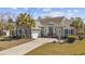Charming home featuring a well-manicured lawn, palm trees, and a convenient two-car garage at 200 Stonefly Ct., Murrells Inlet, SC 29576