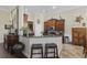 Kitchen featuring an island with bar seating, dark wood cabinetry, granite countertops, and tile floors at 200 Stonefly Ct., Murrells Inlet, SC 29576