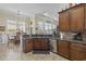 Well-lit kitchen area with dark countertops and cabinetry, stainless steel dishwasher, and wood floors at 200 Stonefly Ct., Murrells Inlet, SC 29576