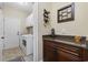 Functional laundry room with white washer and dryer, custom cabinets and wine racks at 200 Stonefly Ct., Murrells Inlet, SC 29576