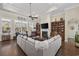 Bright living room with coffered ceiling, built-in bookshelves, a fireplace and a large, comfortable sectional sofa at 200 Stonefly Ct., Murrells Inlet, SC 29576