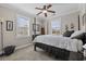 Well-lit bedroom with 4-poster bed, neutral walls, carpeting and large windows with blinds at 200 Stonefly Ct., Murrells Inlet, SC 29576