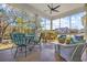 Inviting screened-in porch with comfortable seating and ceiling fan, perfect for relaxing and enjoying the outdoors at 200 Stonefly Ct., Murrells Inlet, SC 29576