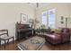 Sunlit sitting room featuring a piano, comfortable chaise lounge, hardwood floors and large windows at 200 Stonefly Ct., Murrells Inlet, SC 29576