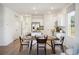 Open floor plan showcases a dining area leading into a kitchen with white cabinets and stainless steel appliances at 2107 Victory Way # 496, Myrtle Beach, SC 29579