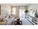 Bright living room featuring a comfortable sofa, stylish coffee table, and sliding glass doors to the outdoors at 2107 Victory Way # 496, Myrtle Beach, SC 29579