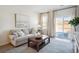 Cozy living room with a comfortable sofa, stylish coffee table, and sliding glass doors to the outdoors at 2107 Victory Way # 496, Myrtle Beach, SC 29579