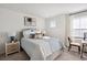 Cozy bedroom with a striped bedspread, nightstand, and a sunny window at 2112 Victory Way # 560, Myrtle Beach, SC 29579
