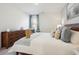 A bright bedroom is furnished with a wooden dresser and a large comfortable bed at 2112 Victory Way # 560, Myrtle Beach, SC 29579