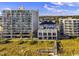 Exterior view of a beachside building complex with a boardwalk leading to the beach at 2208 Bentbill Circle, North Myrtle Beach, SC 29582