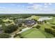 Scenic view of a golf course and club house surrounded by lush greenery and a tranquil lake at 2208 Bentbill Circle, North Myrtle Beach, SC 29582