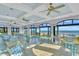 Spacious dining area with ocean views, light blue chairs, and multiple ceiling fans at 2208 Bentbill Circle, North Myrtle Beach, SC 29582