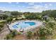 Large community swimming pool with lounge chairs, tables, and manicured landscaping at 2208 Bentbill Circle, North Myrtle Beach, SC 29582