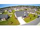 Aerial view of a well-maintained home with lush landscaping and a long driveway in a quiet neighborhood at 240 Hillsborough Dr., Conway, SC 29526