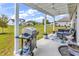 Back patio perfect for outdoor entertaining with grill, seating area, and pergola at 240 Hillsborough Dr., Conway, SC 29526