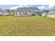 Spacious backyard features a covered patio, lush lawn, and meticulous landscaping, perfect for outdoor enjoyment at 240 Hillsborough Dr., Conway, SC 29526