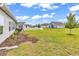 Expansive backyard with lush lawn, garden beds, and a white picket fence, creating a serene outdoor space at 240 Hillsborough Dr., Conway, SC 29526