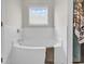Cozy bathtub with white tile surround and a window for natural light, creating a peaceful and relaxing space at 240 Hillsborough Dr., Conway, SC 29526