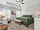 Bright bedroom features a tray ceiling, a ceiling fan, large windows, and a cozy green comforter on an iron bed frame at 240 Hillsborough Dr., Conway, SC 29526