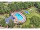 Aerial view of a luxurious community pool surrounded by lush landscaping and comfortable lounging areas at 240 Hillsborough Dr., Conway, SC 29526