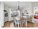 Charming dining room with a rustic wood table, floral chairs, and elegant lighting fixture at 240 Hillsborough Dr., Conway, SC 29526