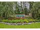 Community entrance sign with beautiful landscaping featuring colorful flowers and lush greenery at 240 Hillsborough Dr., Conway, SC 29526
