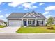Charming single-story home with a manicured lawn, attached garage, and inviting front porch with rocking chairs at 240 Hillsborough Dr., Conway, SC 29526