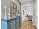 Inviting hallway featuring stylish console table with decor, arched doorway, and wood floors at 240 Hillsborough Dr., Conway, SC 29526