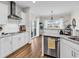 Bright kitchen features stainless steel appliances, granite countertops, white cabinetry, and wood flooring, stylish and functional at 240 Hillsborough Dr., Conway, SC 29526