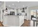 Bright kitchen features white cabinets, granite countertops, stainless steel appliances, and wood floors for a modern look at 240 Hillsborough Dr., Conway, SC 29526