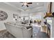 Open living room showcases a fireplace, ceiling fan, and views into dining and sitting areas, perfect for entertaining at 240 Hillsborough Dr., Conway, SC 29526