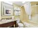 Bathroom featuring a vanity with granite counters, toilet, and a shower/tub with a white curtain at 2401 S Ocean Blvd. S # 267, Myrtle Beach, SC 29577